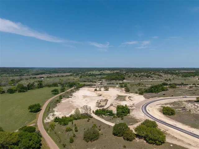 an aerial view of a residential houses with outdoor space