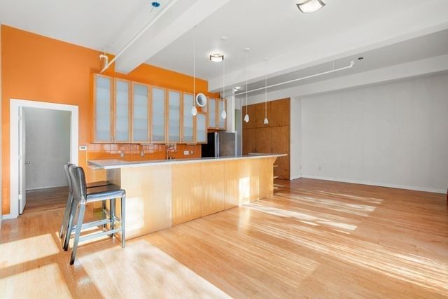 a view of a kitchen with kitchen island and a window
