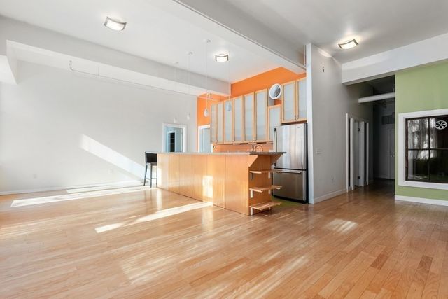 a view of a room with a kitchen