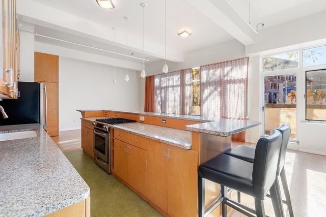a kitchen with a stove a sink and a refrigerator