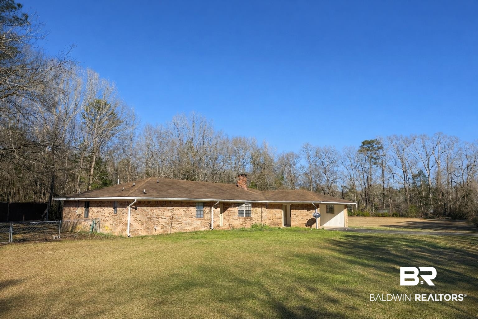 98 Evans Avenue Brewton, AL 36426 - Photo 1 of 18 Back of house featuring a yard and a chimney