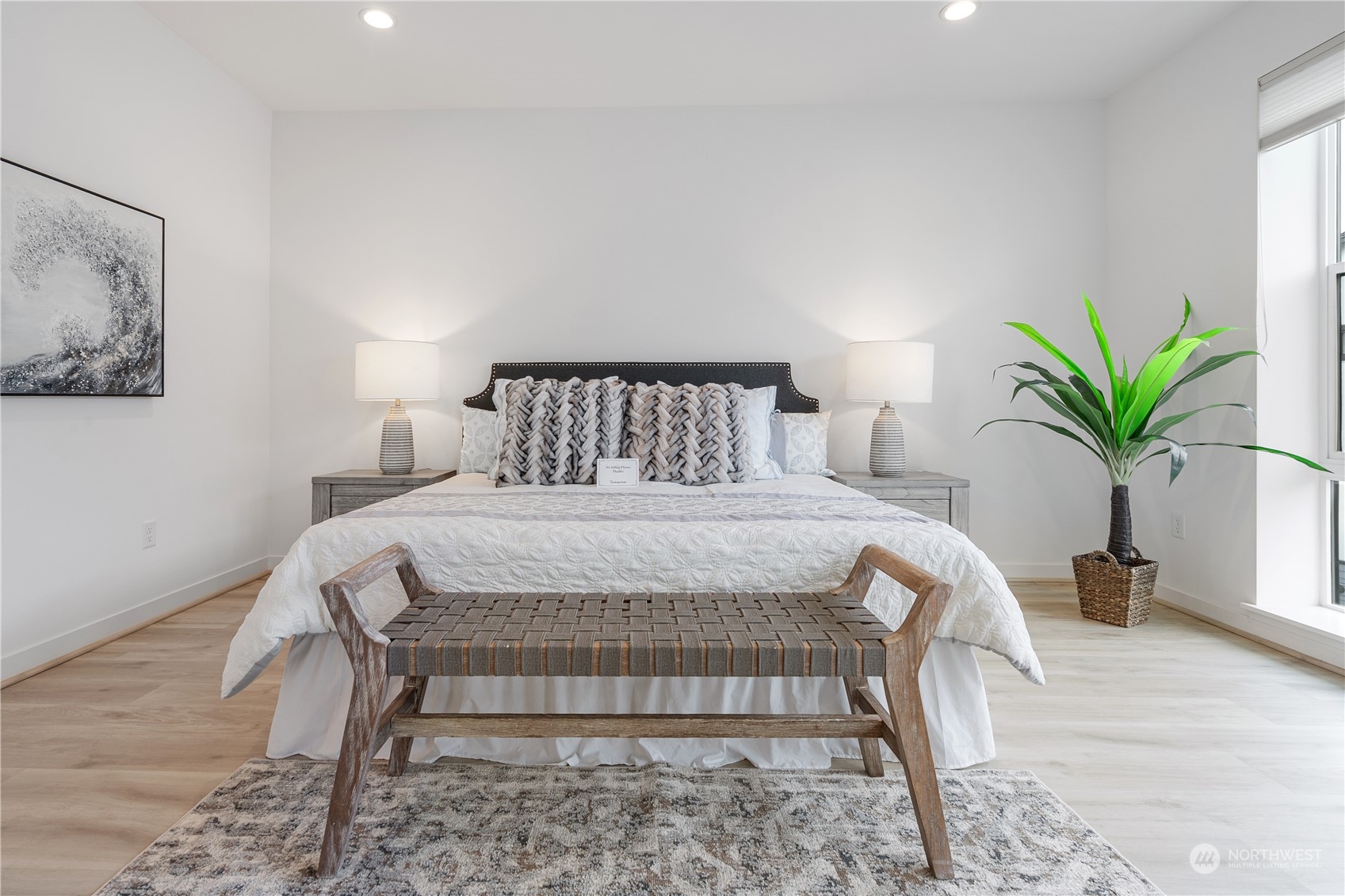 21722 24th Avenue Southeast, Unit A Bothell, WA 98021 - Photo 16 of 38 a bedroom with a large bed and a potted plant