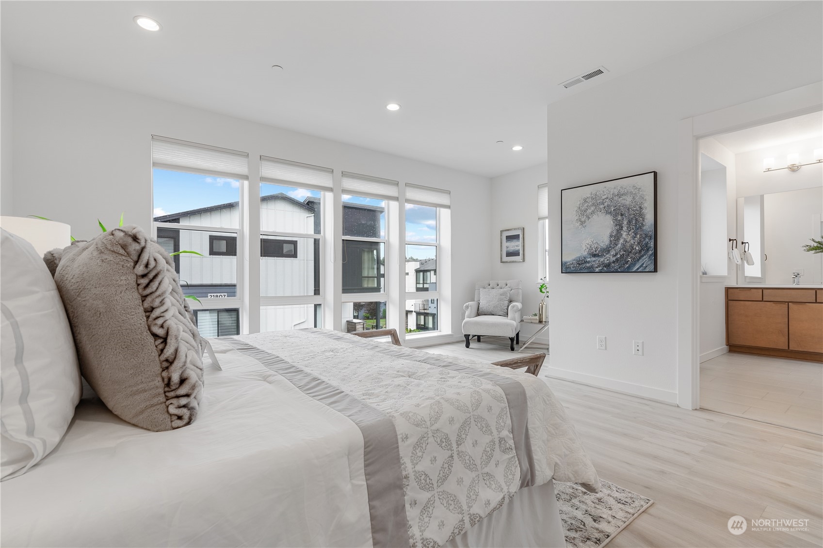 21722 24th Avenue Southeast, Unit A Bothell, WA 98021 - Photo 17 of 38 a spacious bedroom with a bed and a large mirror