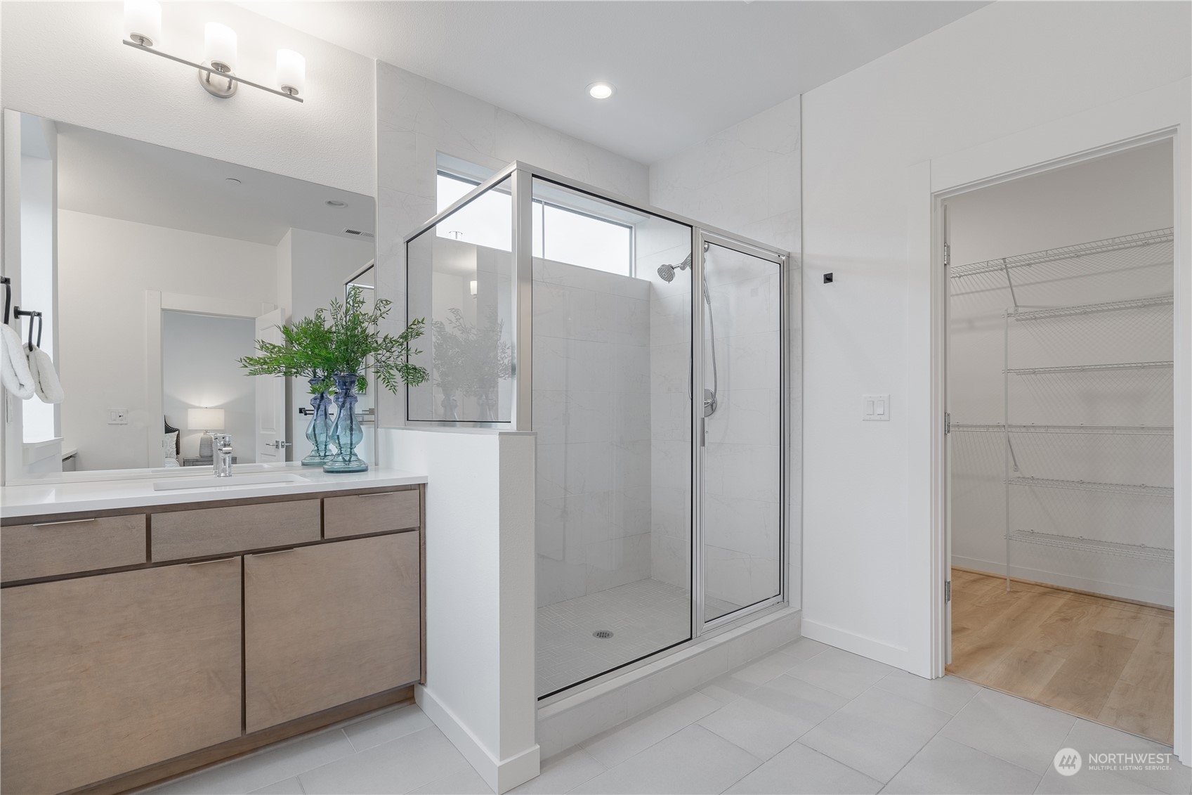 21722 24th Avenue Southeast, Unit A Bothell, WA 98021 - Photo 21 of 38 a bathroom with a double vanity sink and mirror