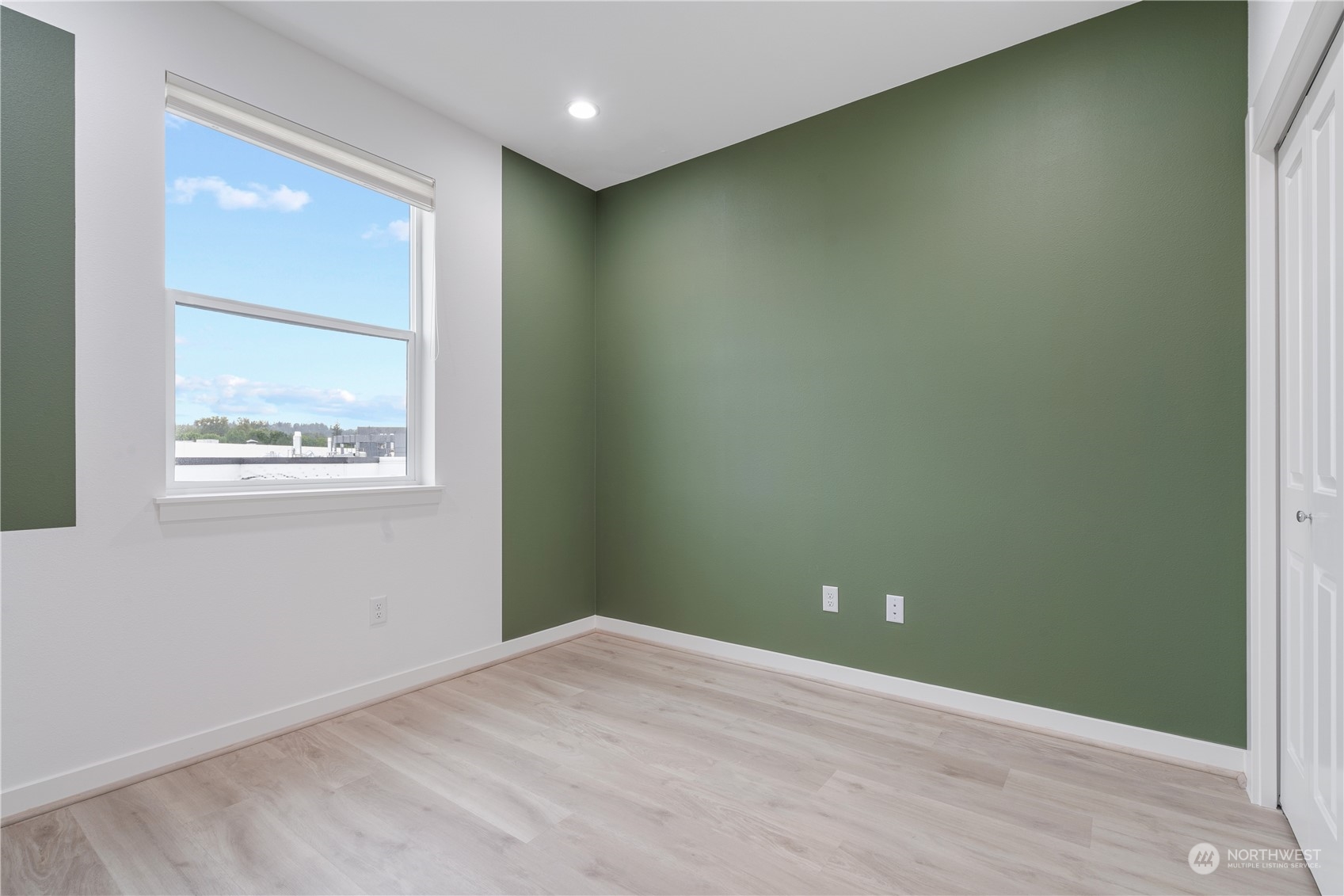 21722 24th Avenue Southeast, Unit A Bothell, WA 98021 - Photo 26 of 38 an empty room with wooden floor and windows