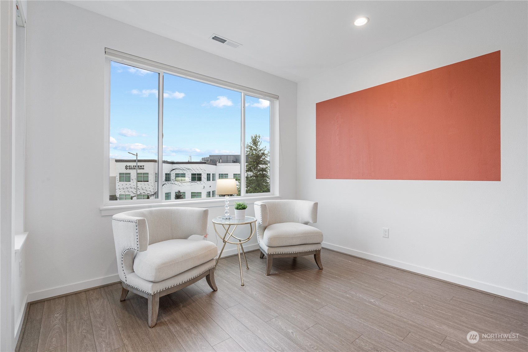 21722 24th Avenue Southeast, Unit A Bothell, WA 98021 - Photo 32 of 38 a living room with furniture and a large window