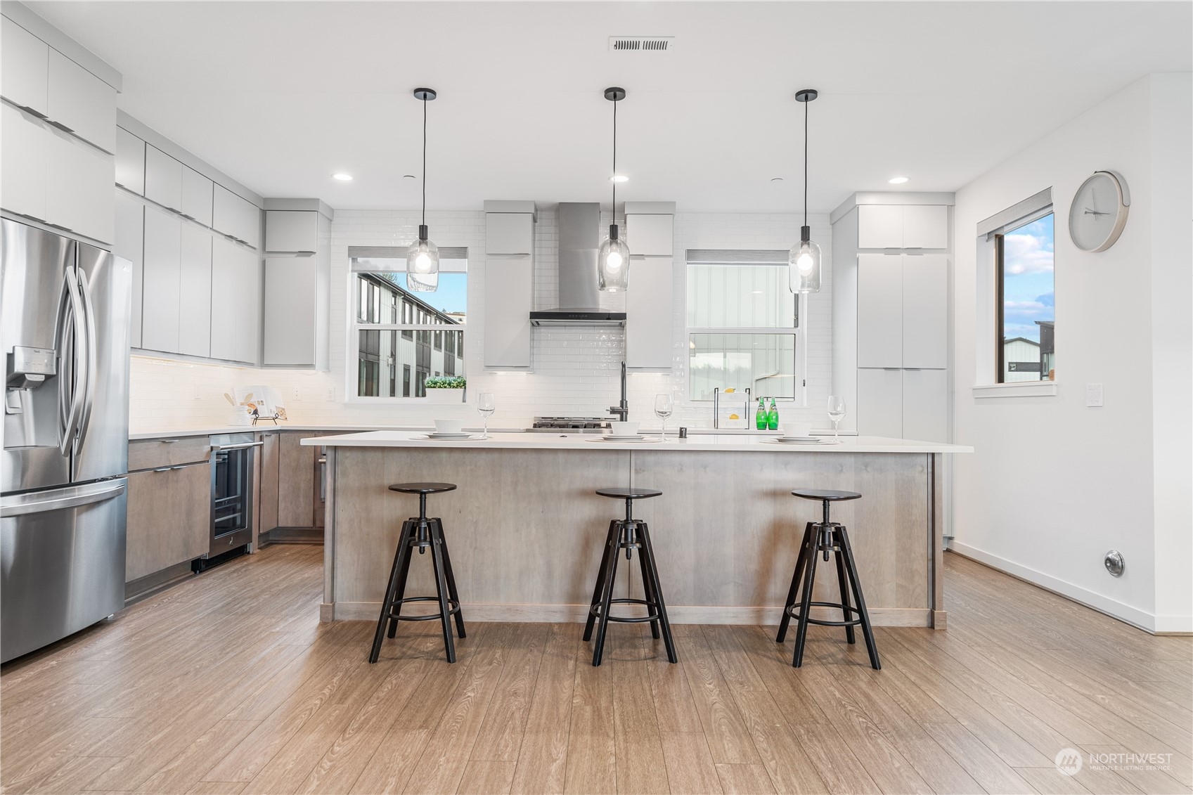 21722 24th Avenue Southeast, Unit A Bothell, WA 98021 - Photo 5 of 38 a kitchen with stainless steel appliances granite countertop a table chairs stove a sink and a refrigerator