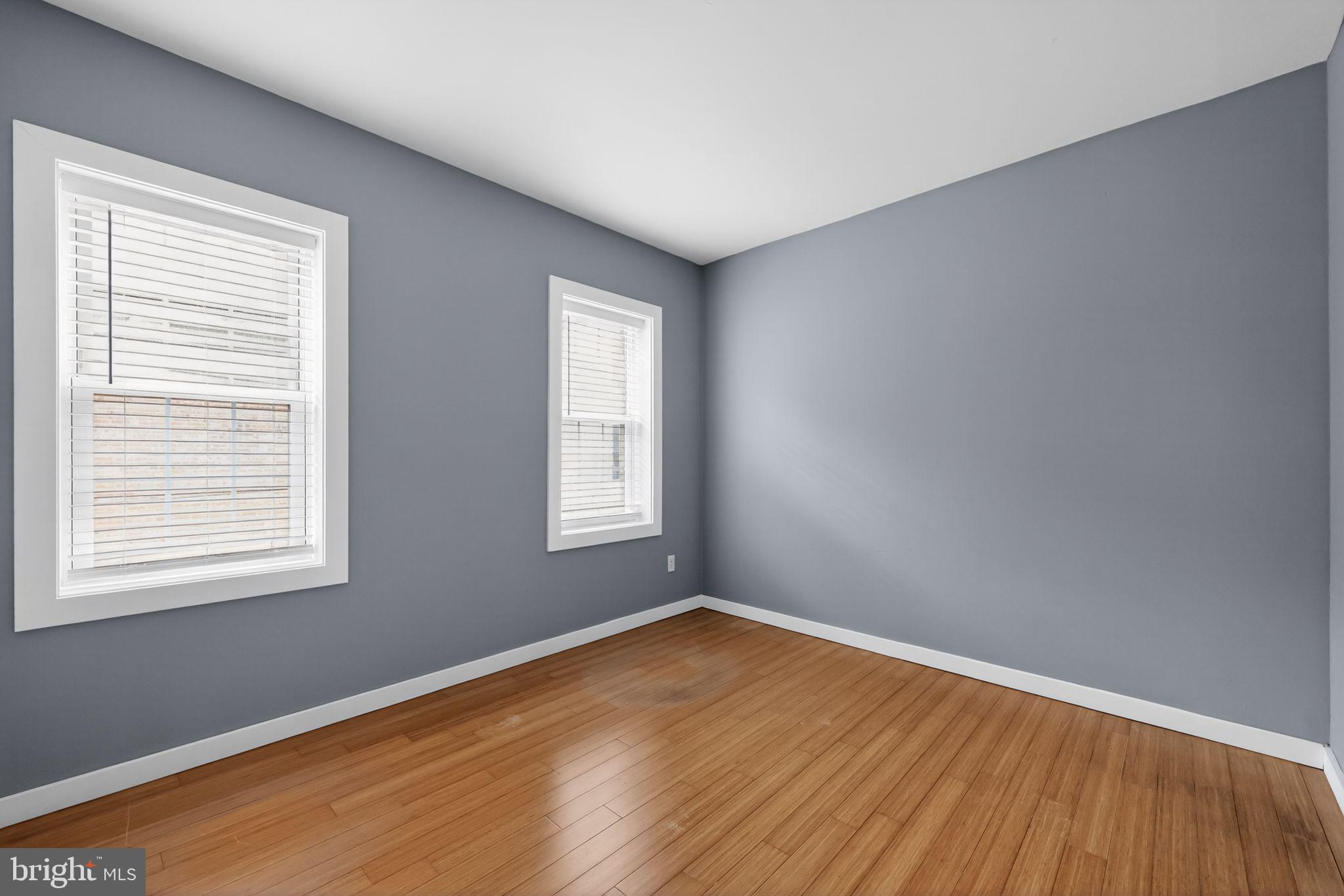 608 Kater Street Philadelphia, PA 19147 - Photo 13 of 30 an empty room with wooden floor and windows