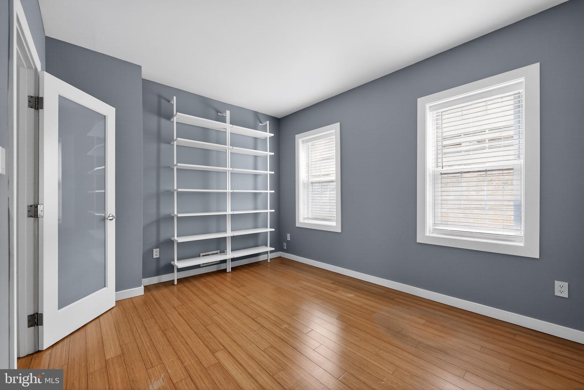 608 Kater Street Philadelphia, PA 19147 - Photo 15 of 30 an empty room with wooden floor and windows