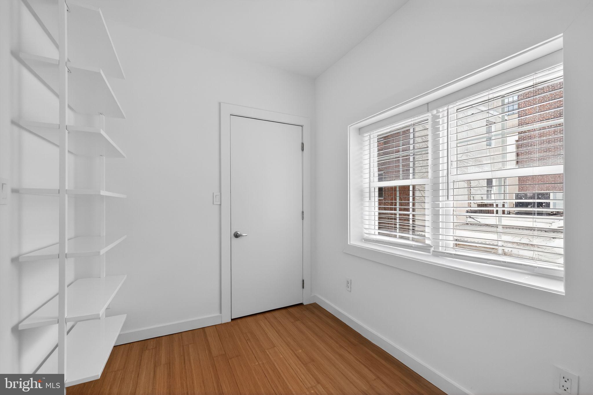 608 Kater Street Philadelphia, PA 19147 - Photo 16 of 30 a view of an empty room with wooden floor and a window