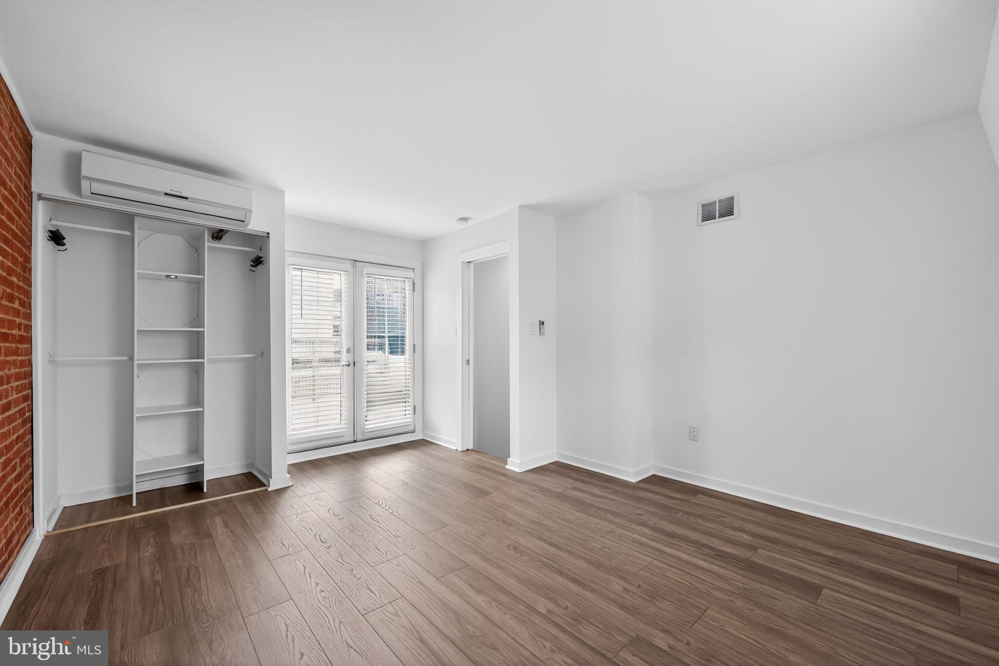 608 Kater Street Philadelphia, PA 19147 - Photo 17 of 30 a view of an empty room with wooden floor and a window