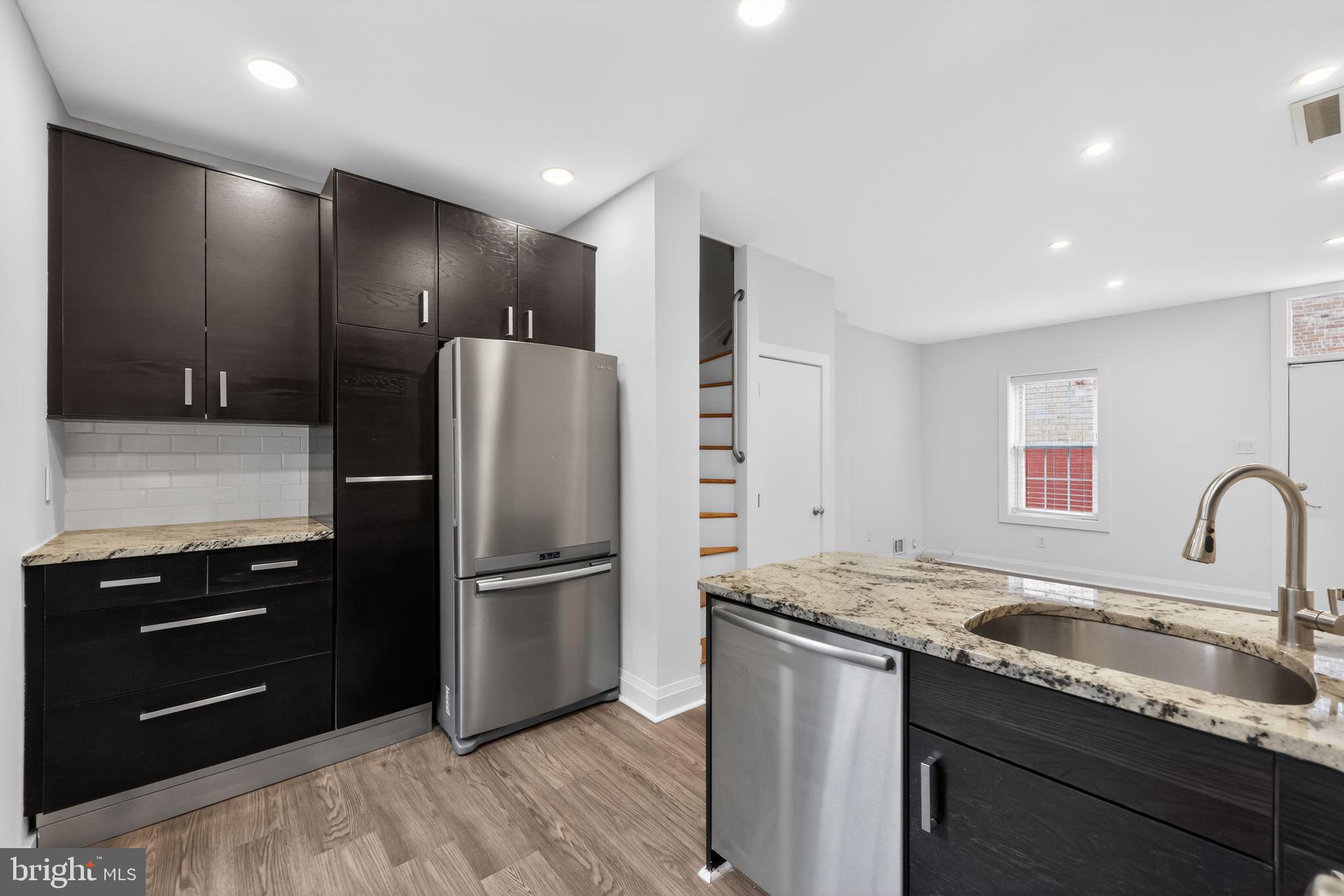 608 Kater Street Philadelphia, PA 19147 - Photo 18 of 30 a kitchen with stainless steel appliances granite countertop a refrigerator and a sink