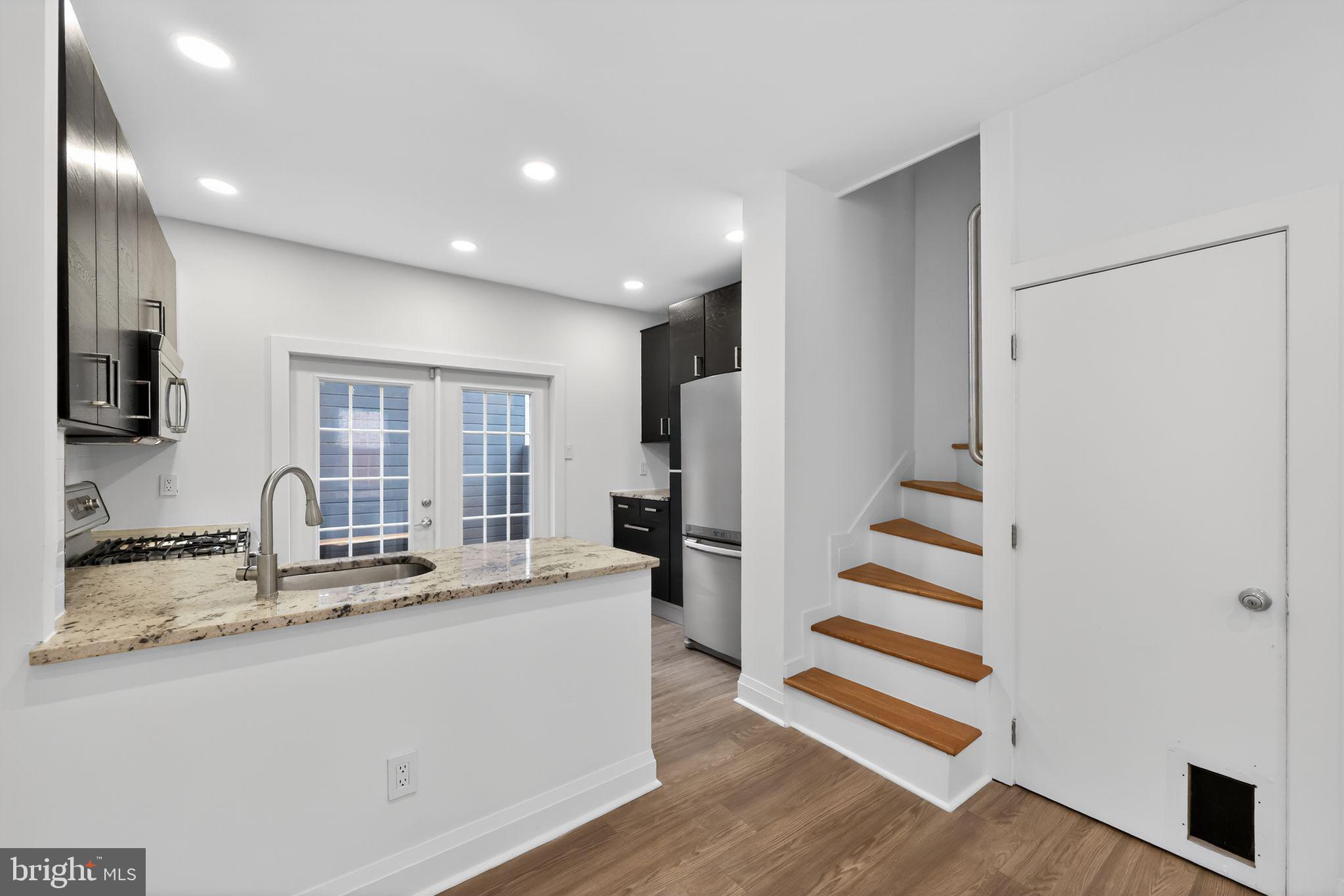 608 Kater Street Philadelphia, PA 19147 - Photo 20 of 30 a kitchen with stainless steel appliances granite countertop a refrigerator and a sink