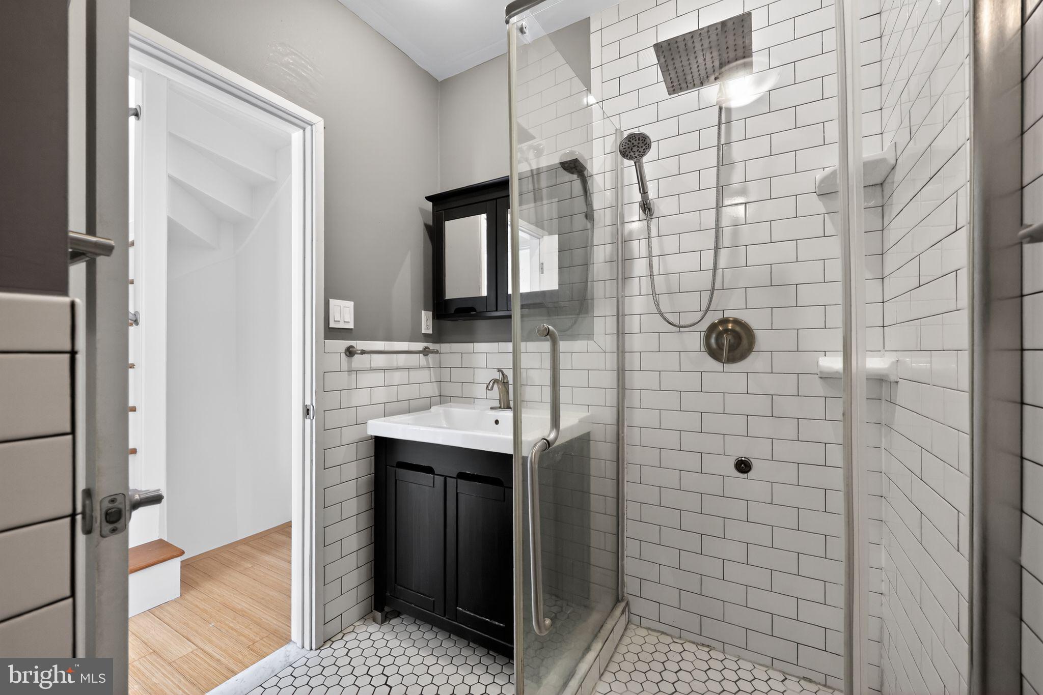 608 Kater Street Philadelphia, PA 19147 - Photo 23 of 30 a bathroom with a shower and a sink