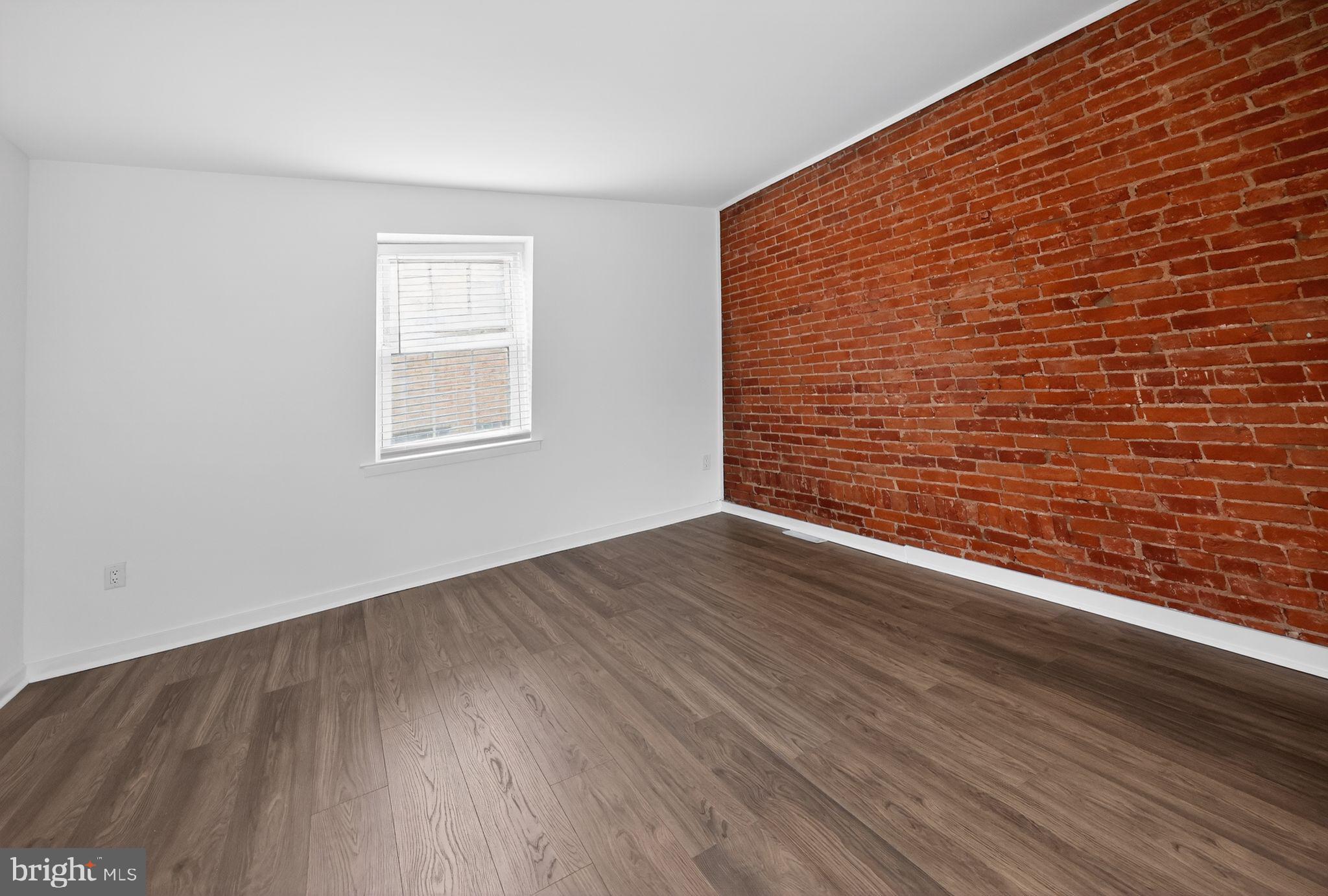 608 Kater Street Philadelphia, PA 19147 - Photo 10 of 30 a view of an empty room with wooden floor and a window