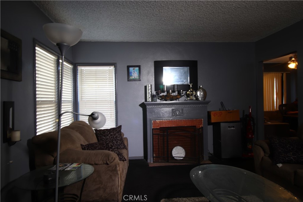 4522 East Rosecrans Avenue Compton, CA 90221 - Photo 19 of 75 a living room with furniture a window and fireplace