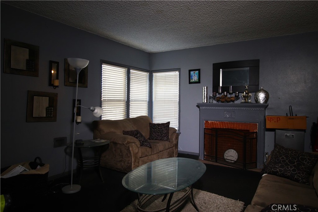 4522 East Rosecrans Avenue Compton, CA 90221 - Photo 20 of 75 a living room with furniture and a fireplace