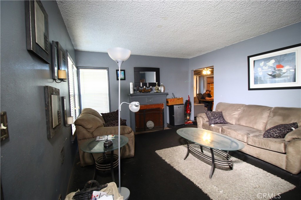 4522 East Rosecrans Avenue Compton, CA 90221 - Photo 22 of 75 a living room with furniture and a fireplace