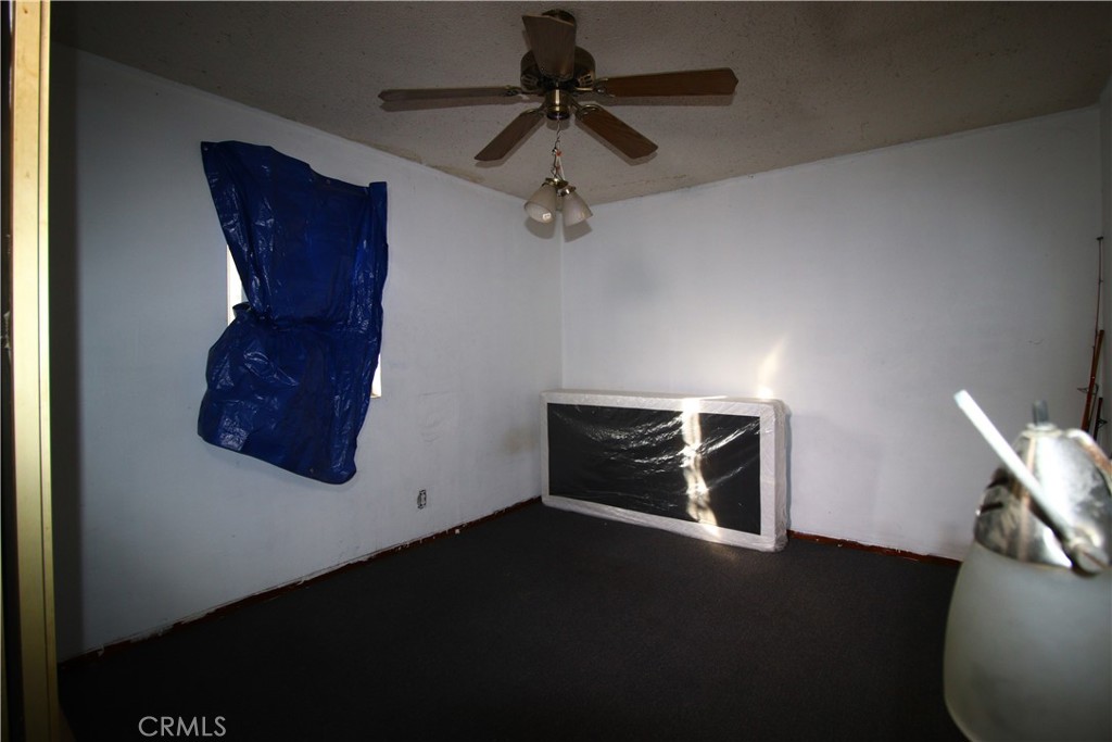 4522 East Rosecrans Avenue Compton, CA 90221 - Photo 30 of 75 a room with a ceiling fan and wooden floor