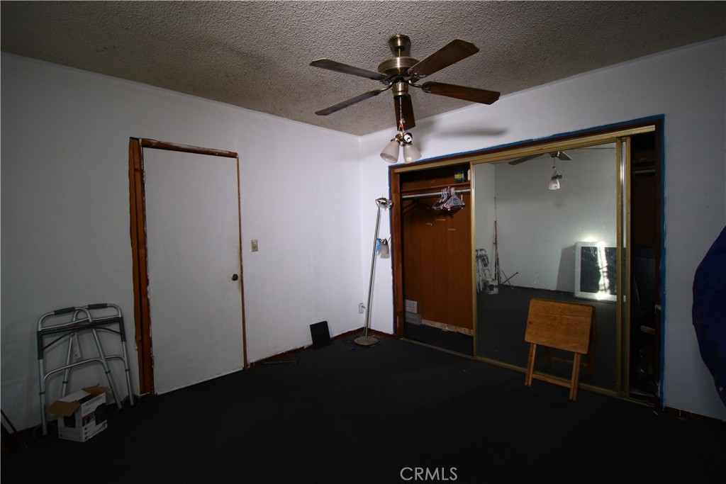4522 East Rosecrans Avenue Compton, CA 90221 - Photo 33 of 75 a bedroom with a bed and a chandelier fan