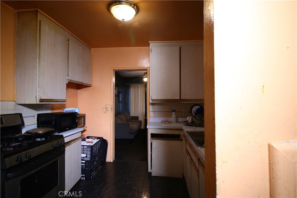 4522 East Rosecrans Avenue Compton, CA 90221 - Photo 39 of 75 a kitchen with a sink and a stove