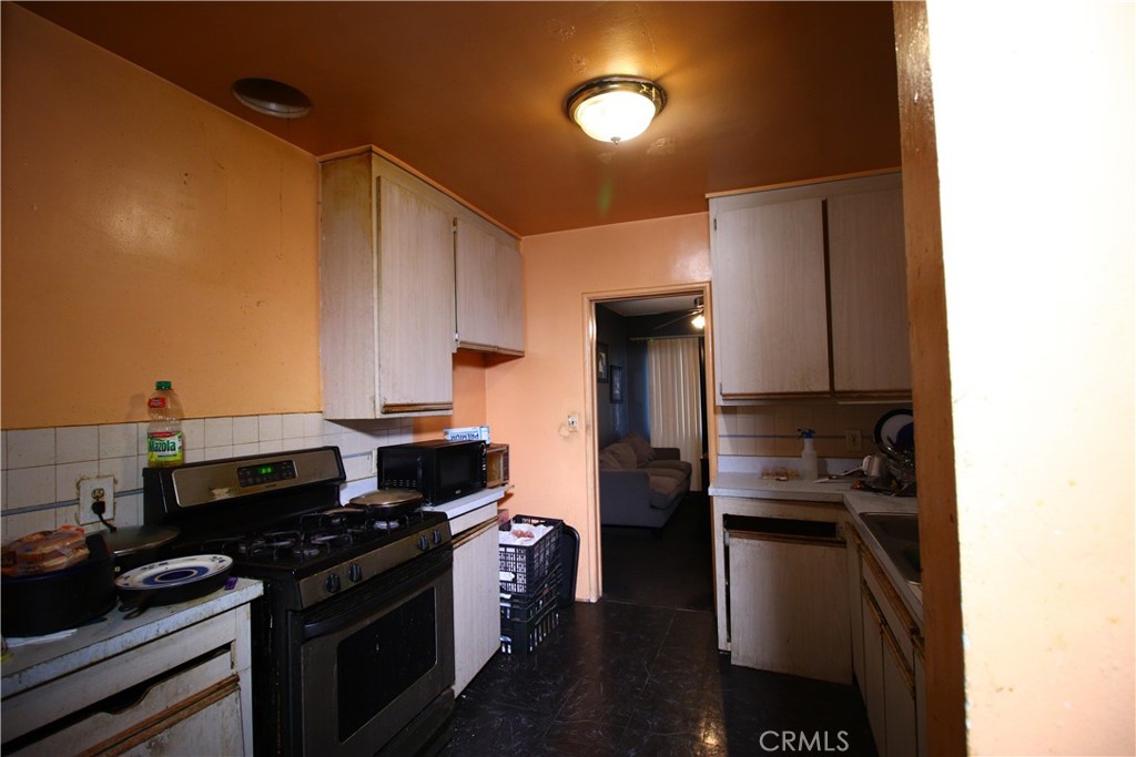4522 East Rosecrans Avenue Compton, CA 90221 - Photo 40 of 75 a kitchen with a sink and a stove top oven
