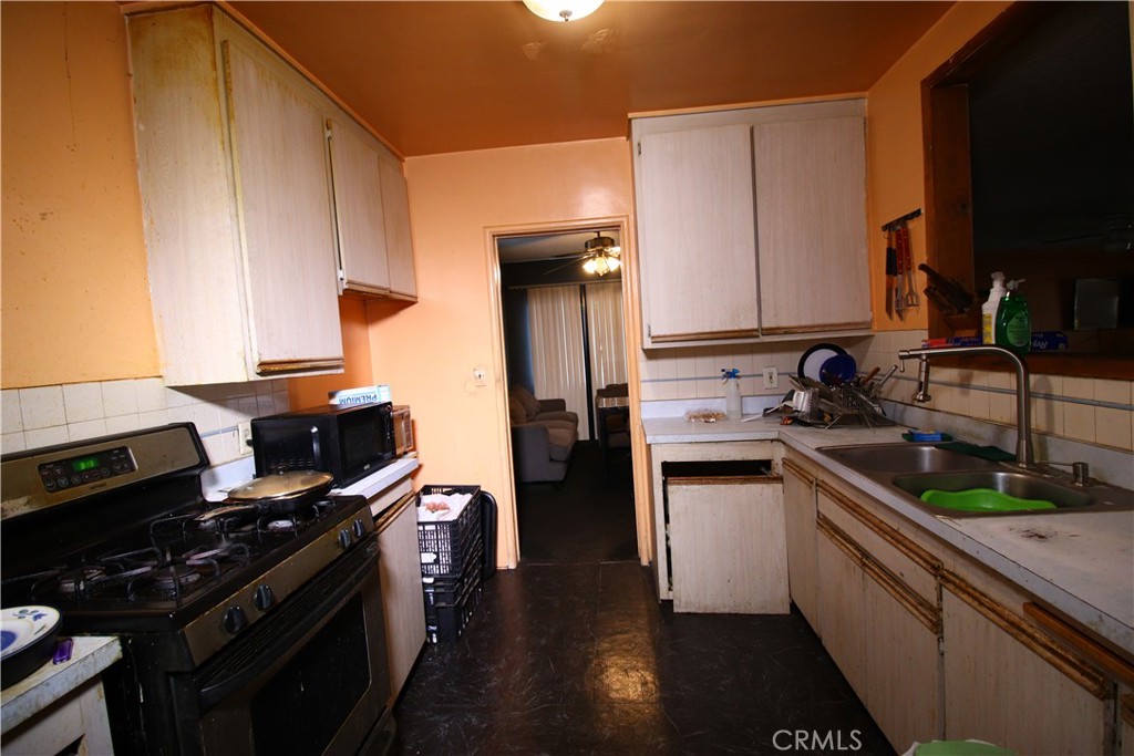 4522 East Rosecrans Avenue Compton, CA 90221 - Photo 41 of 75 a kitchen with a sink appliances and cabinets