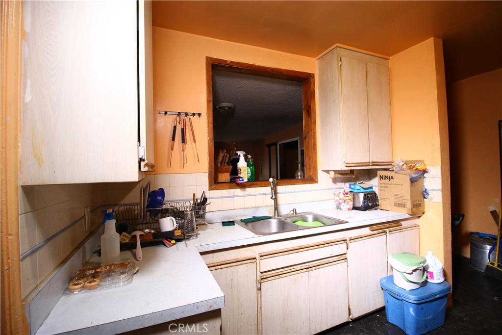 4522 East Rosecrans Avenue Compton, CA 90221 - Photo 43 of 75 a kitchen with a sink and a refrigerator