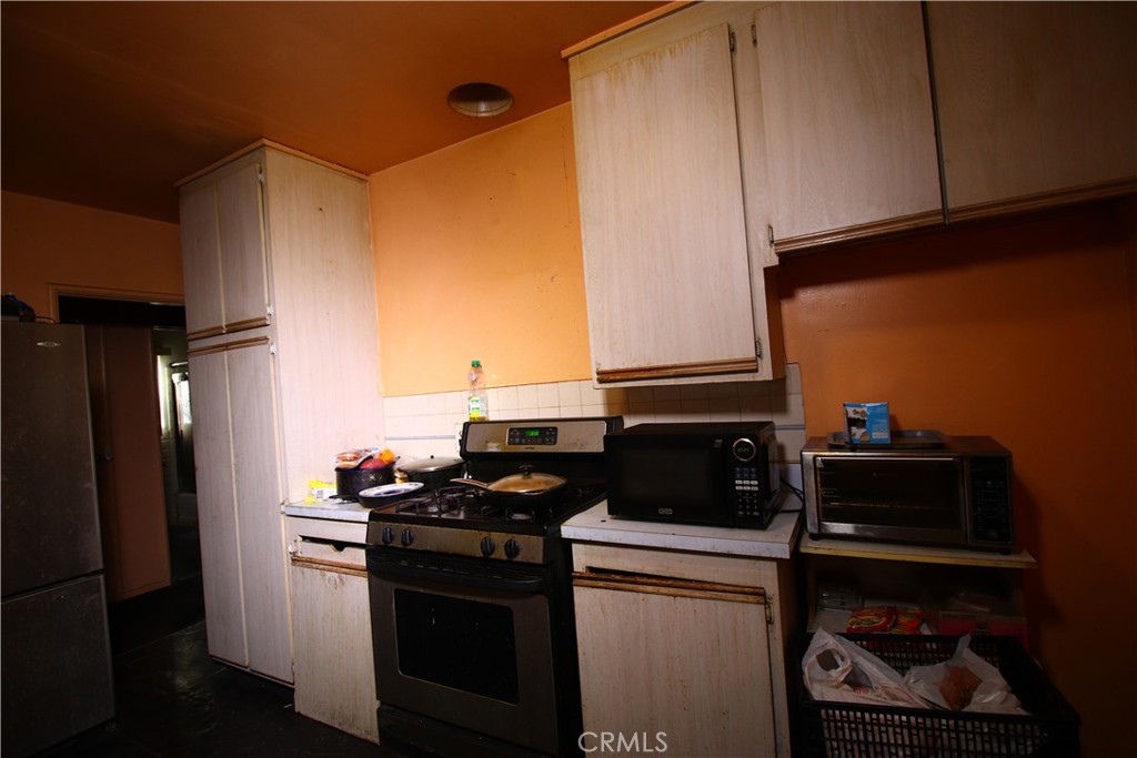 4522 East Rosecrans Avenue Compton, CA 90221 - Photo 44 of 75 a kitchen with a refrigerator and a stove
