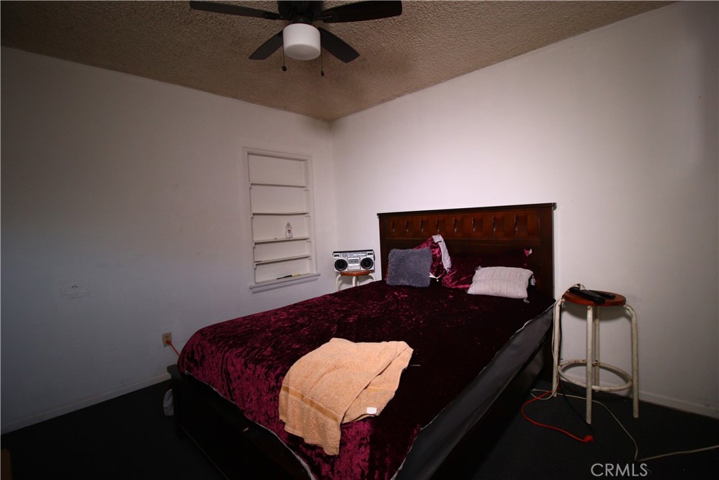 4522 East Rosecrans Avenue Compton, CA 90221 - Photo 48 of 75 a bed sitting in a bedroom next to a lamp