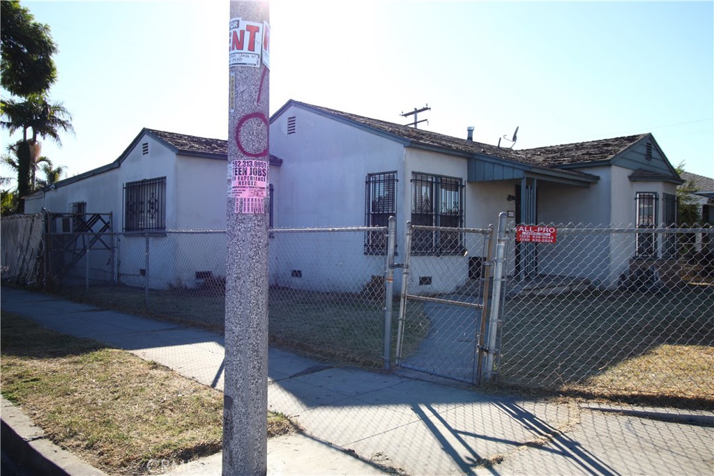 4522 East Rosecrans Avenue Compton, CA 90221 - Photo 5 of 75 a front view of a house with a yard