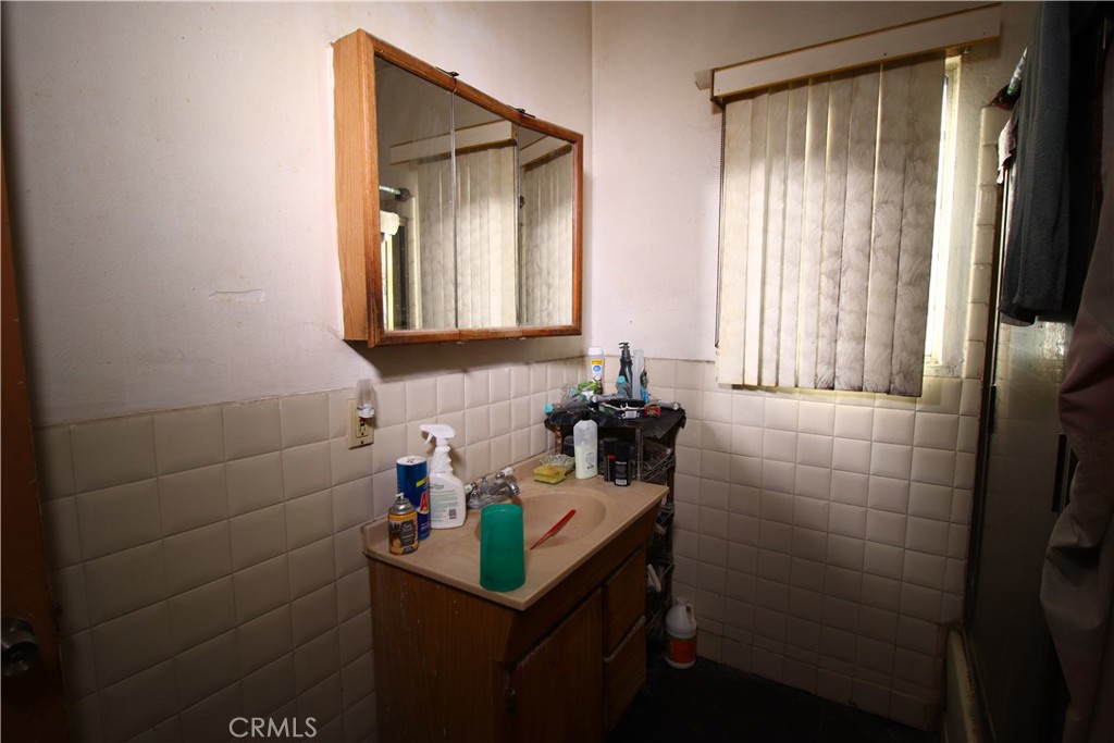 4522 East Rosecrans Avenue Compton, CA 90221 - Photo 52 of 75 a bathroom with a sink a vanity and a mirror
