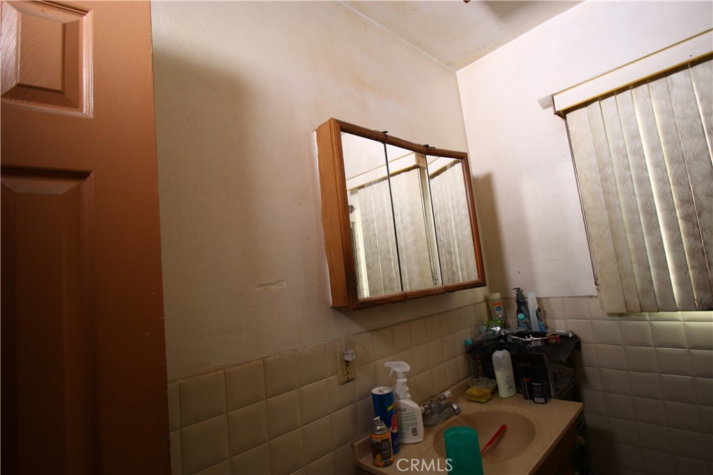 4522 East Rosecrans Avenue Compton, CA 90221 - Photo 55 of 75 a bathroom with a sink and a mirror