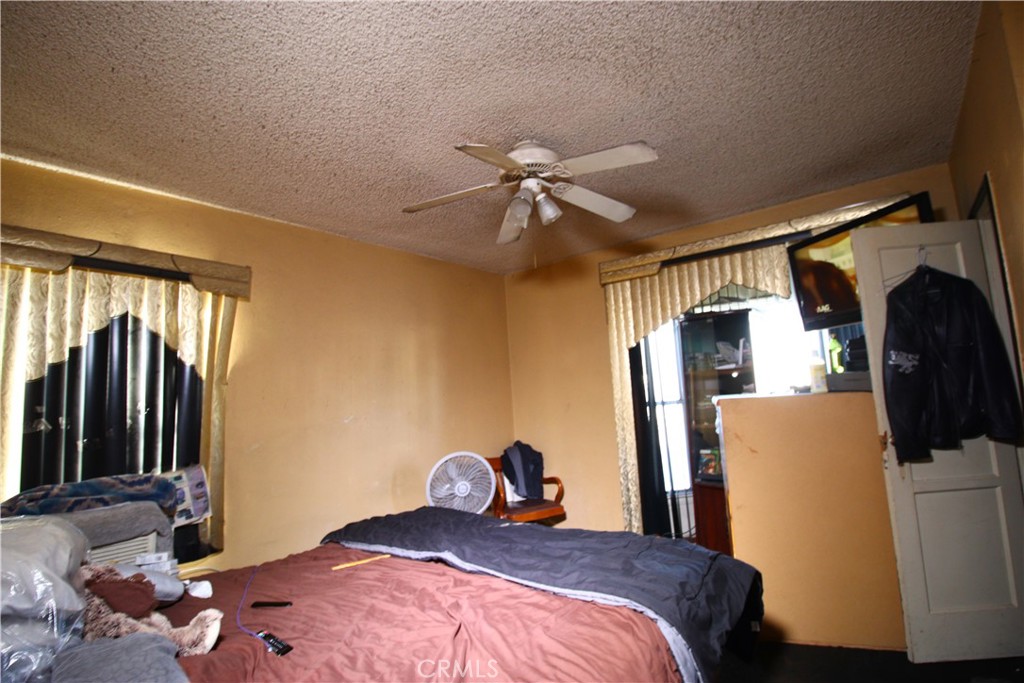 4522 East Rosecrans Avenue Compton, CA 90221 - Photo 56 of 75 a bedroom with a bed and a chandelier