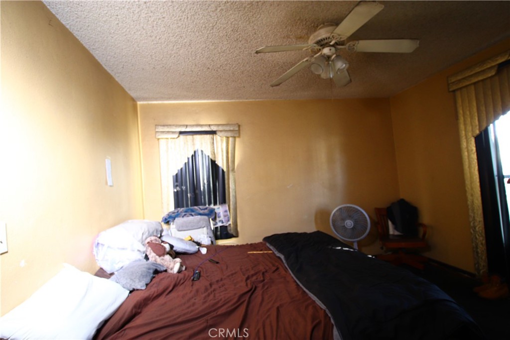 4522 East Rosecrans Avenue Compton, CA 90221 - Photo 57 of 75 a bedroom with a bed and a chandelier