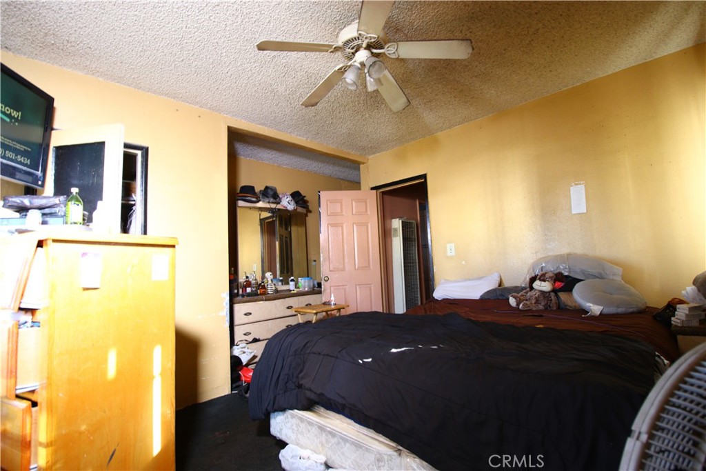 4522 East Rosecrans Avenue Compton, CA 90221 - Photo 58 of 75 a bedroom with a bed and a chandelier