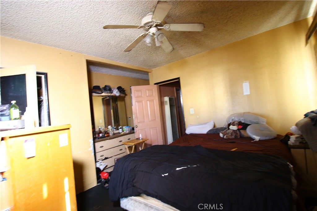 4522 East Rosecrans Avenue Compton, CA 90221 - Photo 59 of 75 a bedroom with a bed and a chandelier