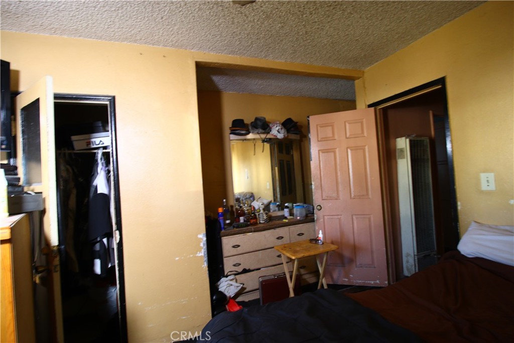 4522 East Rosecrans Avenue Compton, CA 90221 - Photo 60 of 75 a room that has a bed and a dresser in it