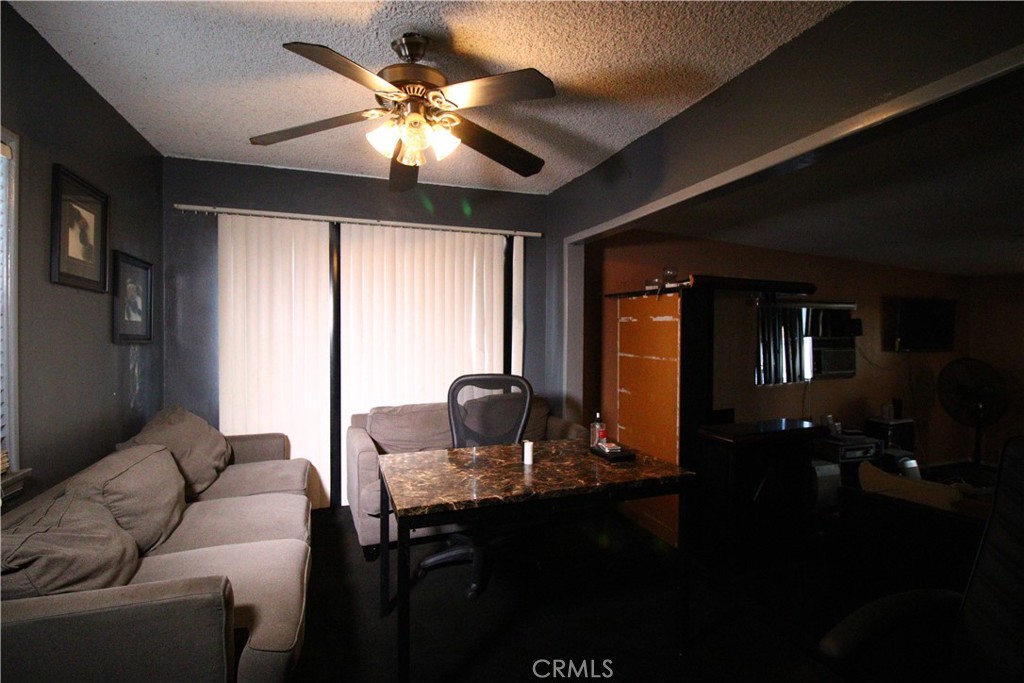 4522 East Rosecrans Avenue Compton, CA 90221 - Photo 63 of 75 a living room with furniture and a chandelier