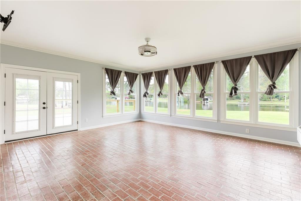 434 Rawley Road Americus, GA 31719 - Photo 31 of 50 a view of an empty room with wooden floor and a window
