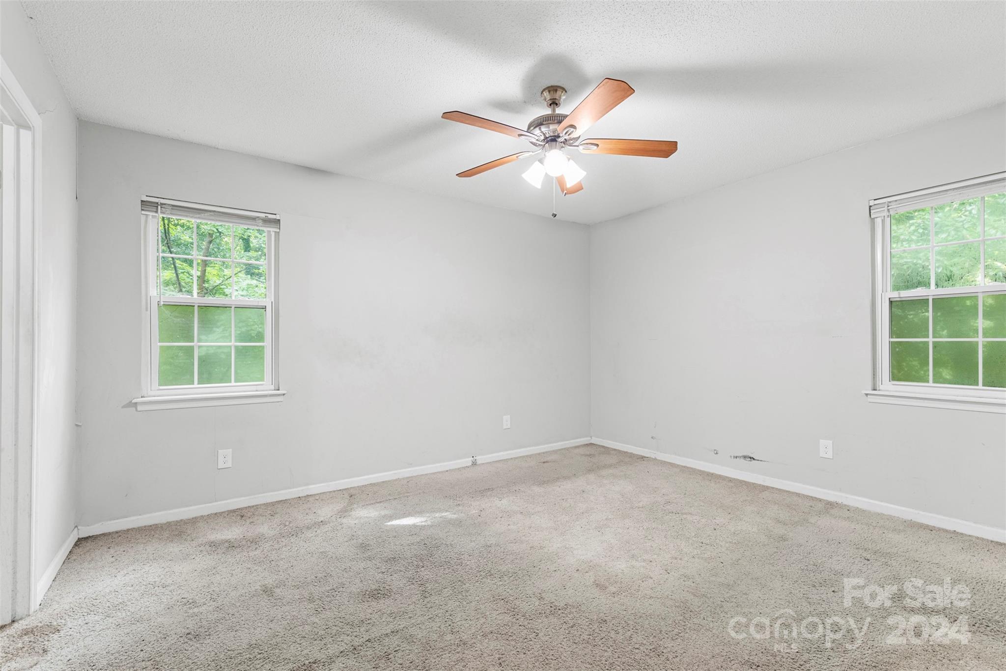 6803 North Ridge Court Charlotte, NC 28215 - Photo 17 of 30 an empty room with windows and fan