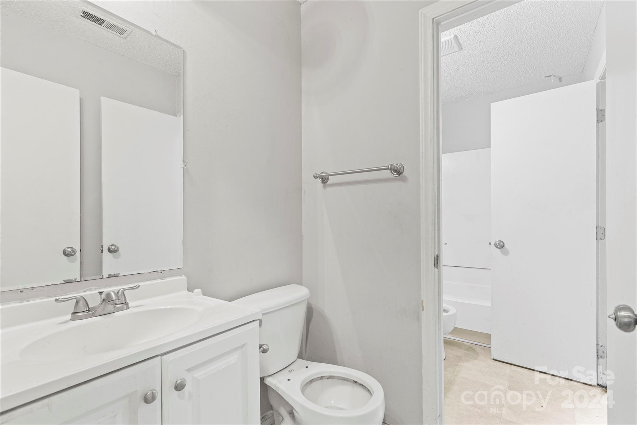 6803 North Ridge Court Charlotte, NC 28215 - Photo 20 of 30 a bathroom with a sink toilet and vanity