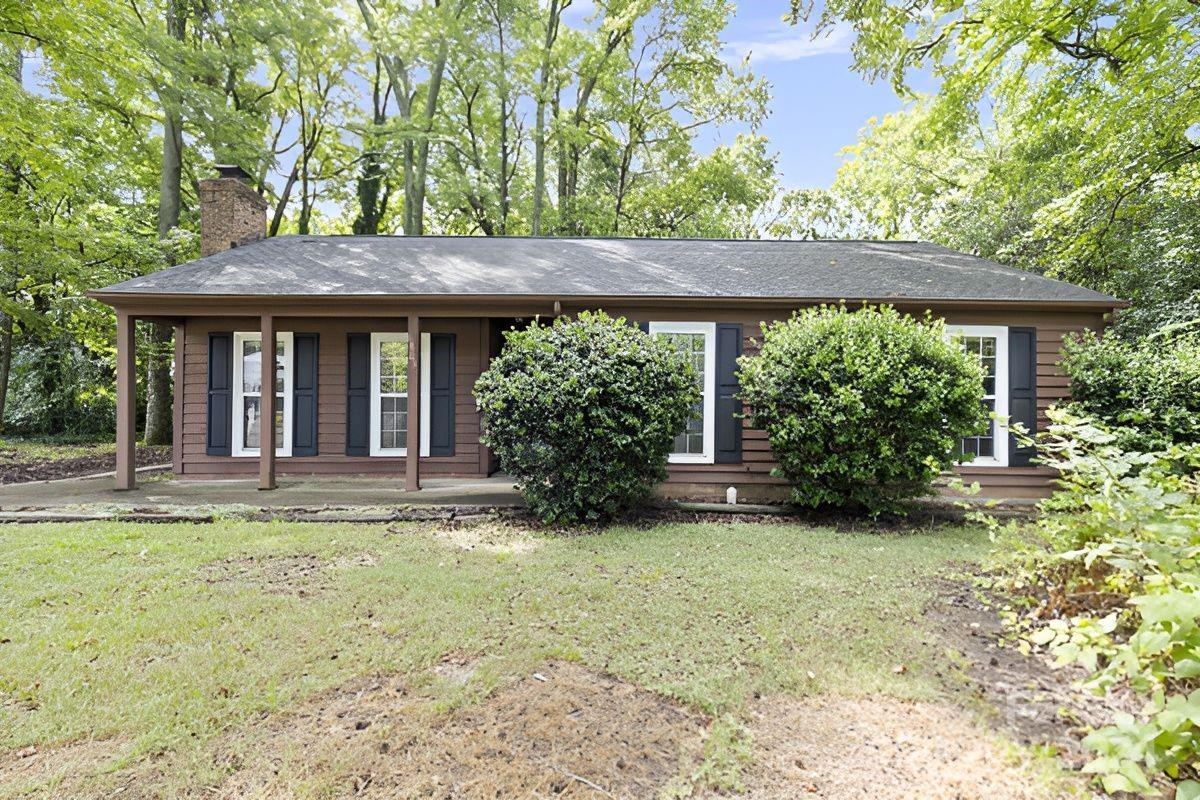 6803 North Ridge Court Charlotte, NC 28215 - Photo 24 of 30 a view of a house with large windows and plants