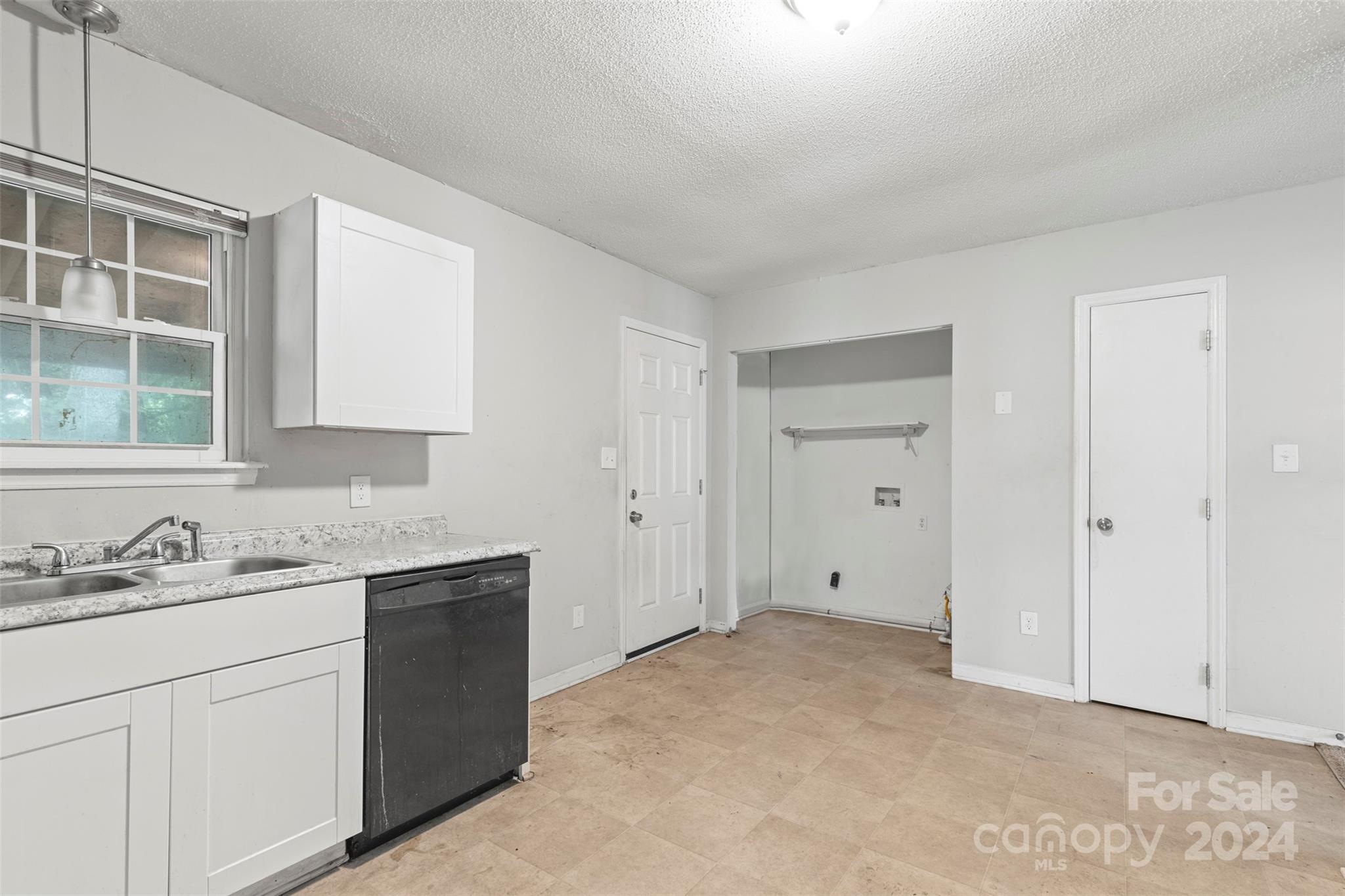 6803 North Ridge Court Charlotte, NC 28215 - Photo 10 of 30 a view of a kitchen with white cabinets