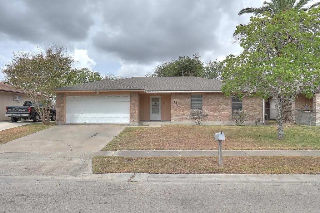 a front view of a house with a yard and garage