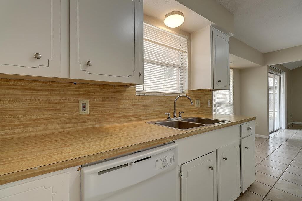 5225 Bonham Street Corpus Christi, TX 78415 - Photo 16 of 40 a kitchen with sink cabinets and window