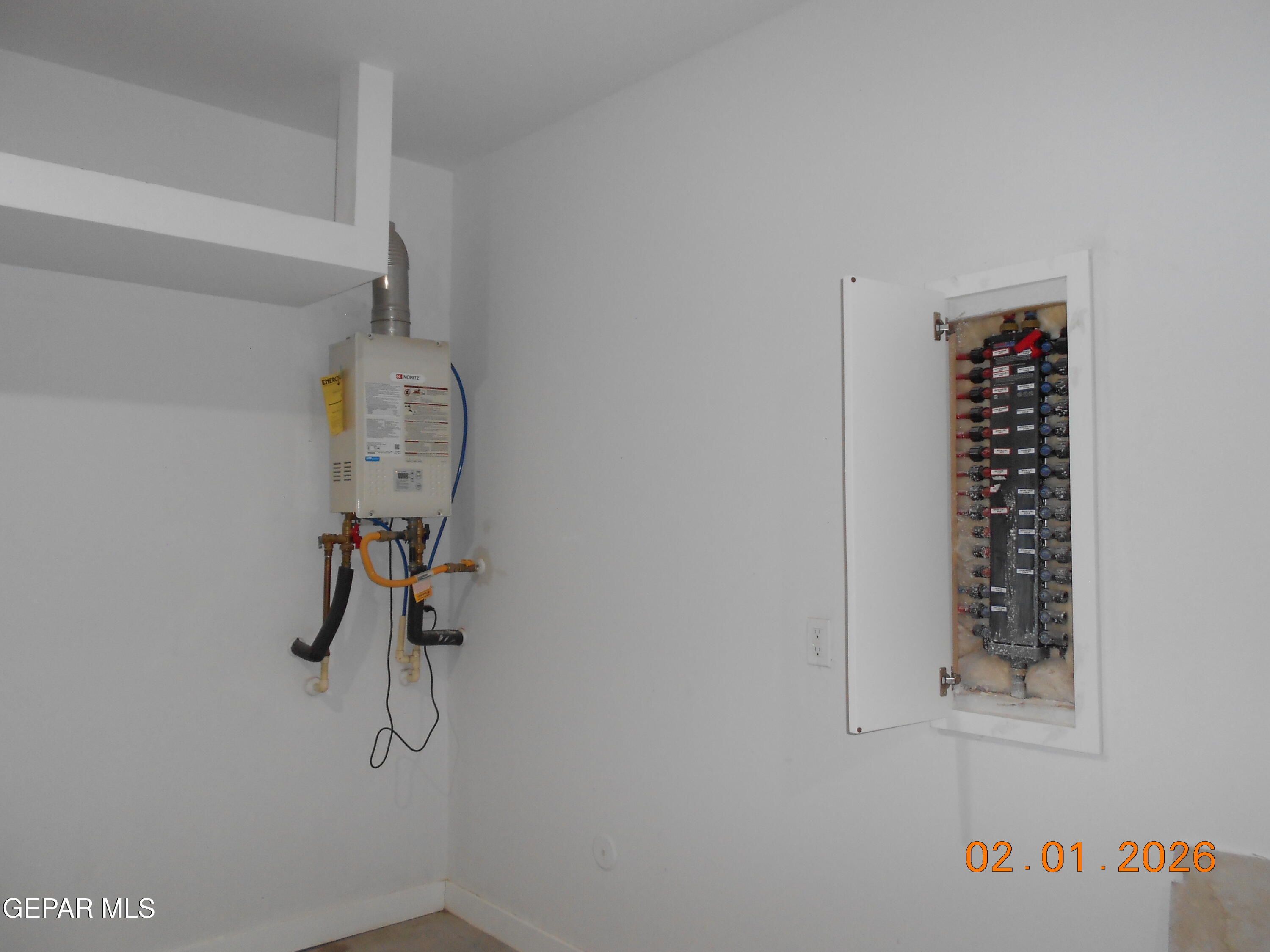 10013 Hueco Jct Road Socorro, TX 79927 - Photo 26 of 27 a view of small space with rack on the wall and a window