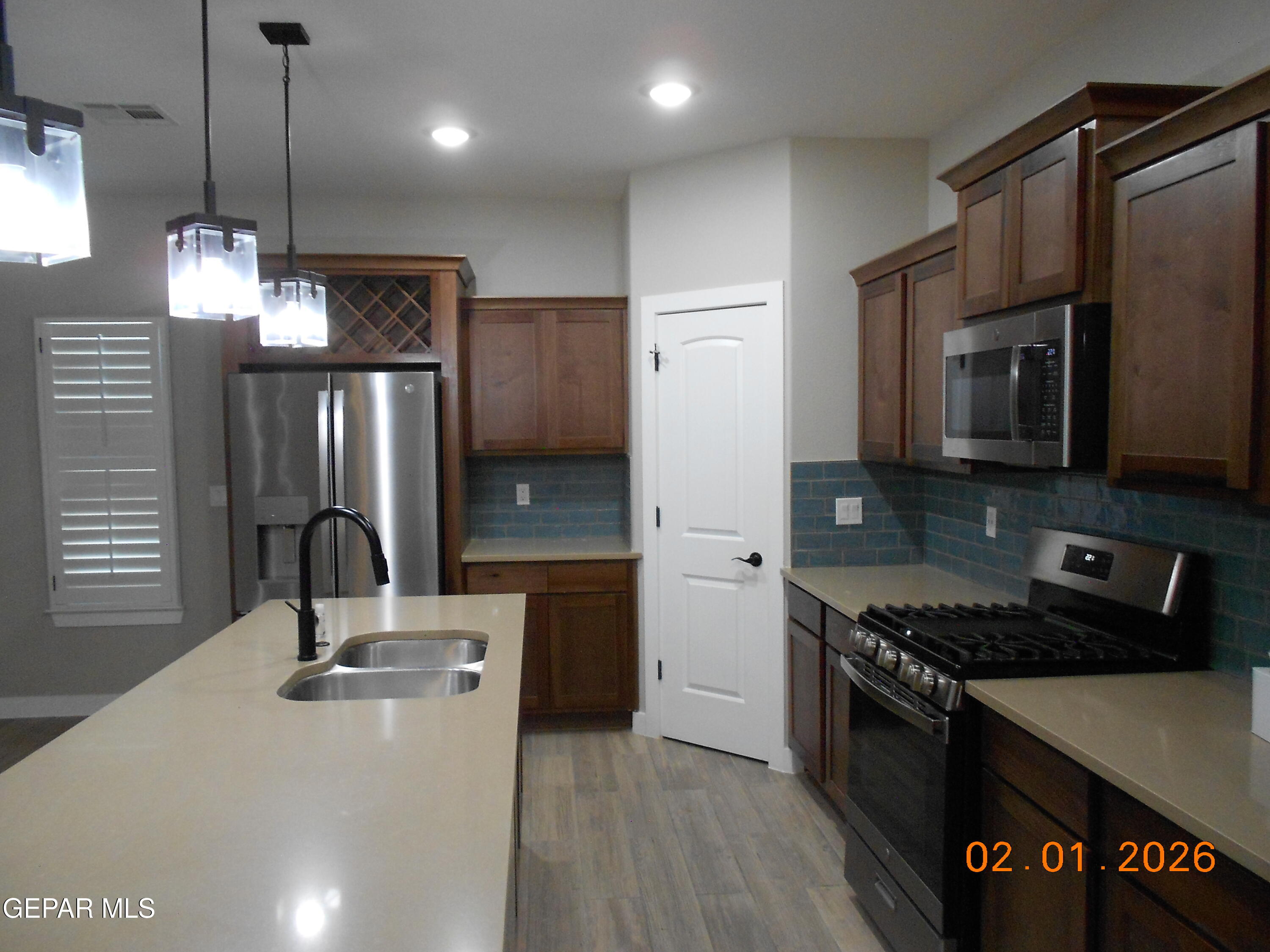 10013 Hueco Jct Road Socorro, TX 79927 - Photo 6 of 27 a kitchen with stainless steel appliances a sink stove and refrigerator