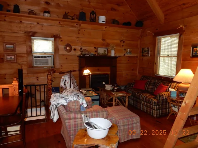 a living room with furniture a window and a fireplace