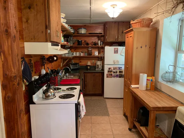 a kitchen with a stove and a refrigerator